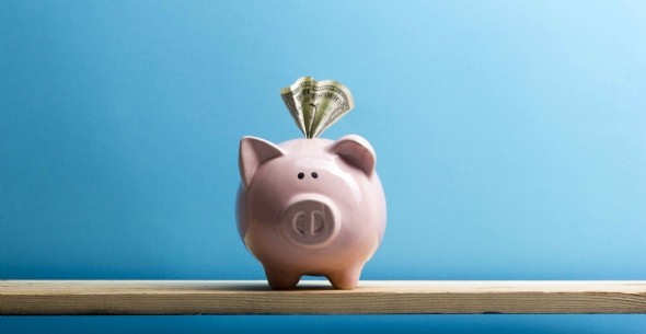 Piggy bank isolated on yellow background.